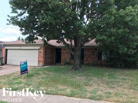 a brick house with a tree in front of it